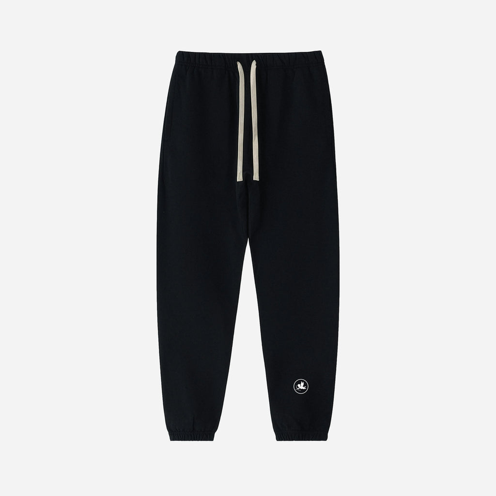 Black jogger pants with a small logo on a light gray background